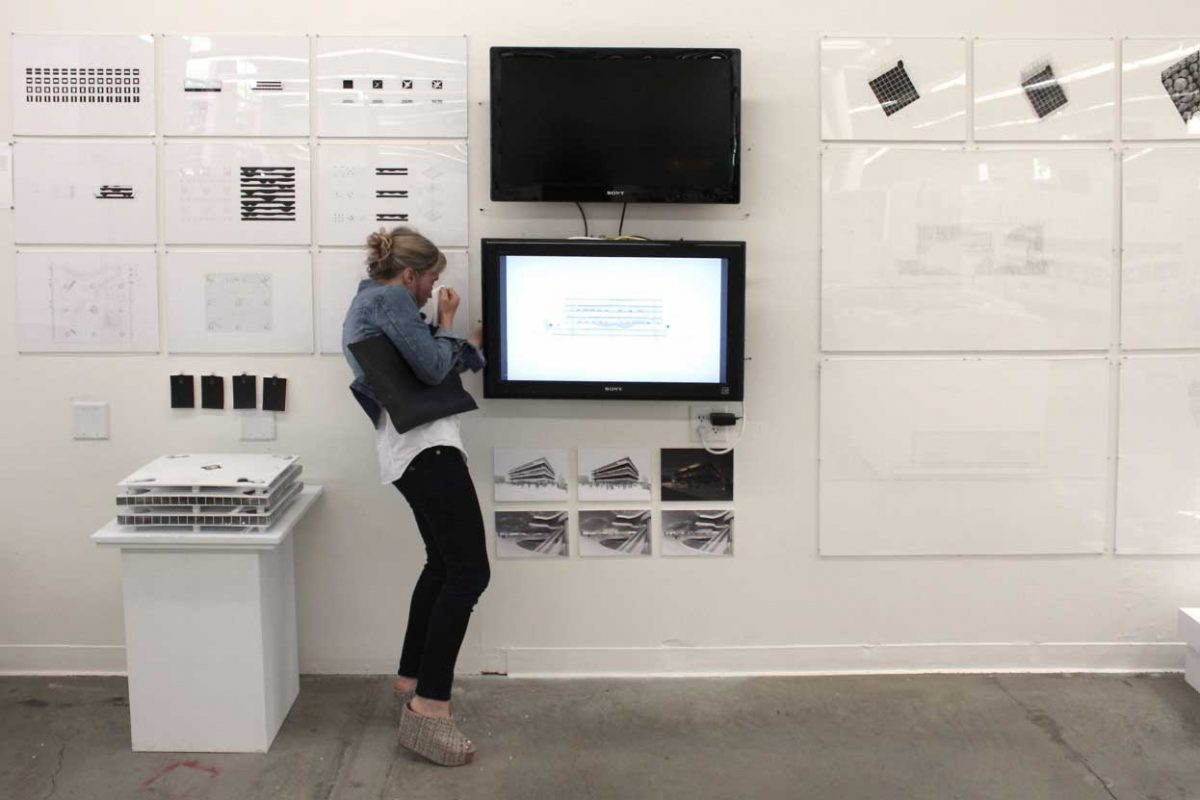 Jennifer Bonner examining student work at Final Reviews 2014.