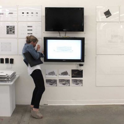 Jennifer Bonner examining student work at Final Reviews 2014.