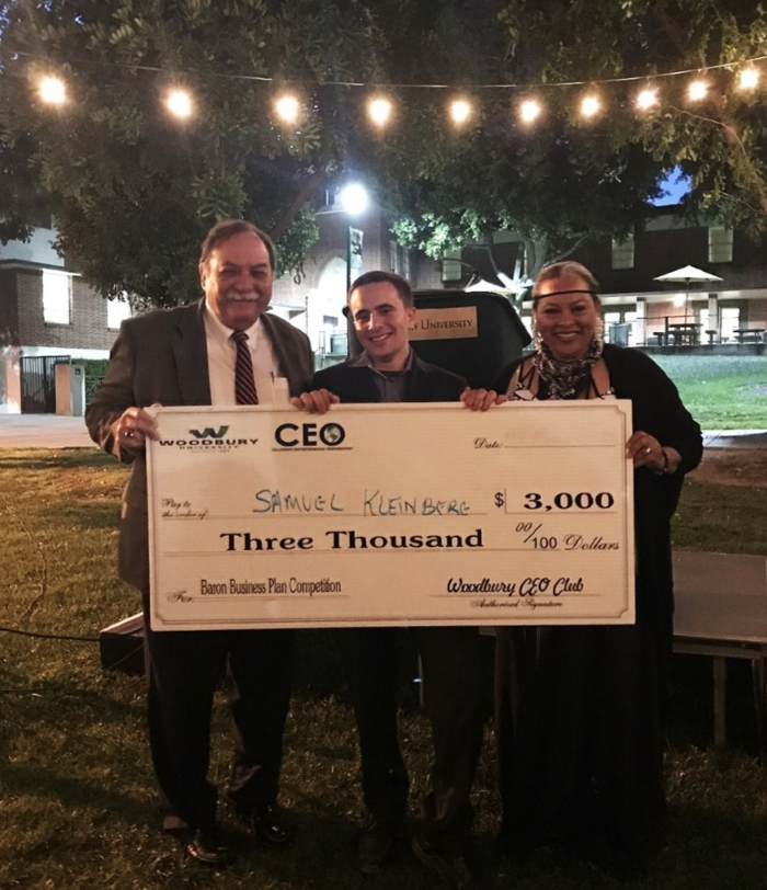 Winner Sam Kleinberg proudly shows his first prize check, flnaked by Dr. Paul Sabolic (left), Advisor of Woodbury's CEO Chapter, and Dr. Joan Marques (right), Dean of the School of Business. 